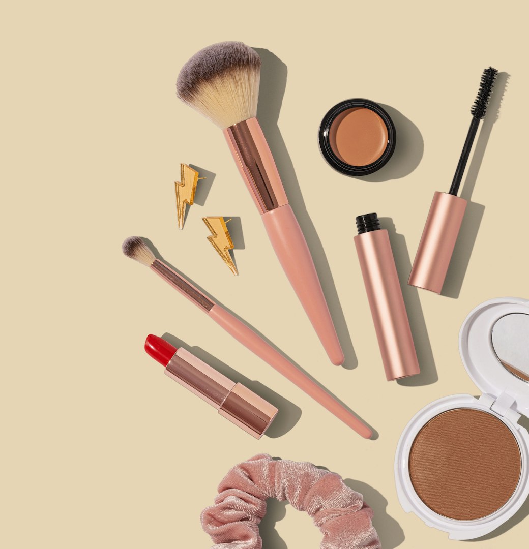 Blush-toned makeup flat lay